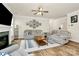 Bright living room with fireplace, ceiling fan, and wood-look flooring at 139 Suggs Mill Dr, Mooresville, NC 28115