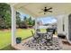 Inviting covered patio area features a ceiling fan, grill, and stylish outdoor furniture for comfortable outdoor living at 139 Suggs Mill Dr, Mooresville, NC 28115