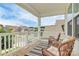 Inviting covered porch with comfortable wicker chairs and view of the neighborhood at 139 Suggs Mill Dr, Mooresville, NC 28115