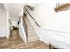 Elegant staircase with wooden railings, wainscoting, and hardwood floors leading to the upper level at 139 Suggs Mill Dr, Mooresville, NC 28115