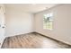 Well-lit bedroom with hardwood floors, a window with a view, and fresh paint at 140 Astor St, Troutman, NC 28166