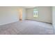 Spacious carpeted bedroom offers a serene escape with a window framing a pleasant neighborhood view at 140 Astor St, Troutman, NC 28166