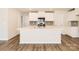 Modern kitchen features a central island, stainless steel appliances, white cabinets and stylish backsplash at 140 Astor St, Troutman, NC 28166