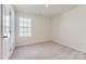 Cozy bedroom with neutral carpet, a window for natural light, and a simple, inviting atmosphere at 144 Astor St, Troutman, NC 28166