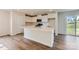 Modern kitchen with white cabinets, quartz countertops, stainless steel appliances, and wood-look flooring at 144 Astor St, Troutman, NC 28166