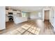 Open-concept living room with a kitchen island, stainless steel appliances, and hardwood floors at 144 Astor St, Troutman, NC 28166