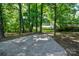 Wooded backyard with a concrete patio at 1513 Greenview Pl, Charlotte, NC 28208