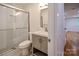 Bathroom featuring a modern vanity and glass shower, adjacent to a hardwood floored hallway at 1513 Greenview Pl, Charlotte, NC 28208