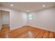 Sunlit bedroom features hardwood floors, neutral walls, and a closet at 1513 Greenview Pl, Charlotte, NC 28208