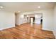 Bright open-concept living room featuring hardwood floors and seamless flow to the kitchen at 1513 Greenview Pl, Charlotte, NC 28208