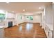Bright, open-concept living area featuring hardwood floors and modern kitchen at 1513 Greenview Pl, Charlotte, NC 28208