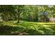 Lush backyard with mature trees, offering a private and serene setting at 1520 21St Ne Ave, Hickory, NC 28601