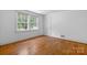 Bright bedroom featuring hardwood floors, a closet, and a large window that floods the space with natural light at 1520 21St Ne Ave, Hickory, NC 28601