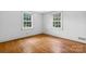 Comfortable bedroom featuring pristine hardwood floors and two windows that provide an abundance of natural light at 1520 21St Ne Ave, Hickory, NC 28601