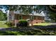 Side view of brick home with green lawn, asphalt driveway and mature shade trees offering curb appeal at 1520 21St Ne Ave, Hickory, NC 28601
