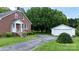 Brick home with a long driveway leading to a detached two-car garage, complemented by mature landscaping at 1520 21St Ne Ave, Hickory, NC 28601