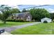Brick home with an extended driveway leading to a detached two-car garage, surrounded by a green lawn at 1520 21St Ne Ave, Hickory, NC 28601