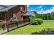Brick home with a wheelchair ramp and a side porch surrounded by manicured bushes and trees at 1520 21St Ne Ave, Hickory, NC 28601