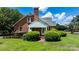 Well-maintained brick home featuring a wheelchair ramp and manicured landscaping, enhancing accessibility and curb appeal at 1520 21St Ne Ave, Hickory, NC 28601