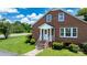 Brick home featuring a front porch with white railings and stairs, surrounded by green lawn and shrubbery at 1520 21St Ne Ave, Hickory, NC 28601