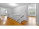 Hallway that features hardwood floors, a staircase, and a door opening into a bright room with natural light at 1520 21St Ne Ave, Hickory, NC 28601