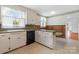 Well lit kitchen with plenty of storage and a breakfast bar, seamlessly blending functionality with a touch of vintage style at 1520 21St Ne Ave, Hickory, NC 28601