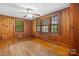 Charming living room featuring beautiful hardwood floors and wood-paneled walls and ample natural light at 1520 21St Ne Ave, Hickory, NC 28601