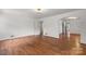 Bright living room featuring hardwood floors, fresh paint, and an arched doorway that adds architectural interest at 1520 21St Ne Ave, Hickory, NC 28601