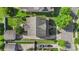 A high aerial view of the house's roof and surrounding yards, garages, driveways, and mature landscaping at 17327 Summers Walk Blvd, Davidson, NC 28036