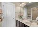 Bathroom featuring double vanity sinks, modern fixtures, and a large mirror at 17327 Summers Walk Blvd, Davidson, NC 28036