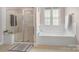 Bathroom features separate shower and tub area, plus large window offering natural light at 17327 Summers Walk Blvd, Davidson, NC 28036