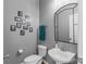 Cozy powder room featuring gray walls, modern fixtures, and tasteful decorative touches at 17327 Summers Walk Blvd, Davidson, NC 28036