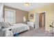 Bright bedroom featuring neutral tones, a window with blinds, and soft carpet flooring at 17327 Summers Walk Blvd, Davidson, NC 28036
