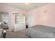 Bedroom featuring a white dresser, butterfly decor, and soft natural light at 17327 Summers Walk Blvd, Davidson, NC 28036
