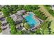 Aerial view of the community swimming pool and clubhouse nestled among mature trees and lush landscaping at 17327 Summers Walk Blvd, Davidson, NC 28036