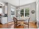 Sunlit dining area boasting hardwood floors, large windows, and elegant chandelier at 17327 Summers Walk Blvd, Davidson, NC 28036