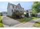 Two-story home with long driveway leading to detached garage, and manicured front yard at 17327 Summers Walk Blvd, Davidson, NC 28036