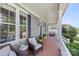 Inviting front porch with comfortable seating, plants and view of front yard at 17327 Summers Walk Blvd, Davidson, NC 28036