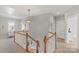 Bright hallway with natural light, wooden railing staircase and neutral colors at 17327 Summers Walk Blvd, Davidson, NC 28036