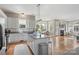 Open kitchen with white cabinets, stainless steel appliances, and a seamless flow to the living area at 17327 Summers Walk Blvd, Davidson, NC 28036