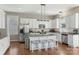Well-lit kitchen featuring white cabinets, granite countertops, and stainless steel appliances at 17327 Summers Walk Blvd, Davidson, NC 28036