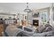 Open-concept living space with fireplace, hardwood floors, and seamless flow to the kitchen at 17327 Summers Walk Blvd, Davidson, NC 28036