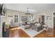 Spacious living room with hardwood floors, a cozy sectional sofa, and abundant natural light at 17327 Summers Walk Blvd, Davidson, NC 28036