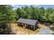 Aerial view of a gray-sided home surrounded by lush trees and a spacious yard at 1870 Hwy 49 None, New London, NC 28127