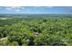 Bird's-eye view of a wooded area featuring a home surrounded by lush trees at 1870 Hwy 49 None, New London, NC 28127