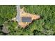 Aerial view of a home surrounded by dense trees, featuring a gravel driveway at 1870 Hwy 49 None, New London, NC 28127