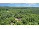 Overhead view of a house nestled among lush trees under a blue sky at 1870 Hwy 49 None, New London, NC 28127