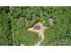 Aerial view of a home nestled in a dense forest featuring a long driveway at 1870 Hwy 49 None, New London, NC 28127