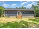 Back of home featuring a staircase leading to a back porch and a spacious lawn at 1870 Hwy 49 None, New London, NC 28127