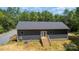 Backyard view of a home with gray siding and a wooden staircase at 1870 Hwy 49 None, New London, NC 28127